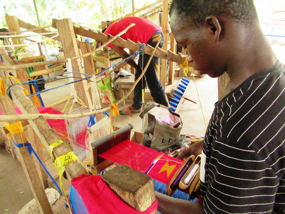 Kente weaver at loom in Adanwomase