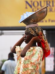Young woman with drinking water on head