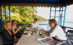 Family having breakfast on the Volta River