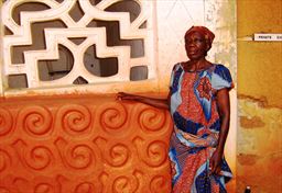 caretaker in front of Akwasi Sima shrine at Adako Jachie