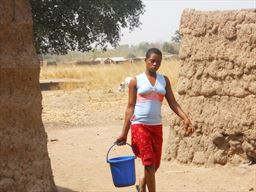 young woman carrying water in northern Ghana