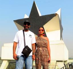 couple in front of black star of ghana