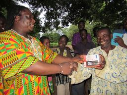 Giving a phone in a village in Ghana