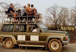 group atop safari vehicle ghana