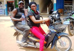 passenger with female motobike driver in Ghana