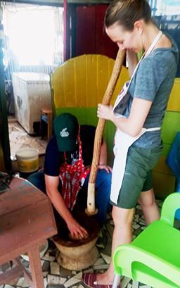 pounding fufu at cooking class in Ghana