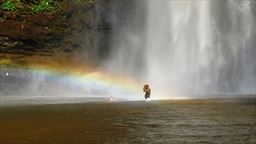 Visitor in rainbow at Wli Falls