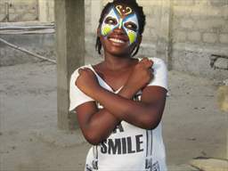 smiling girl with painted face ghana