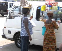 Vendors coming to a vehicle in Ghana